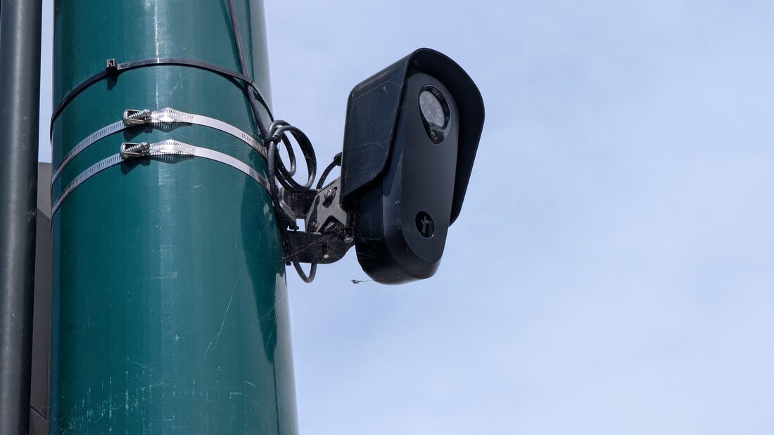 A Flock Safety license plate reader camera mounted on a street pole